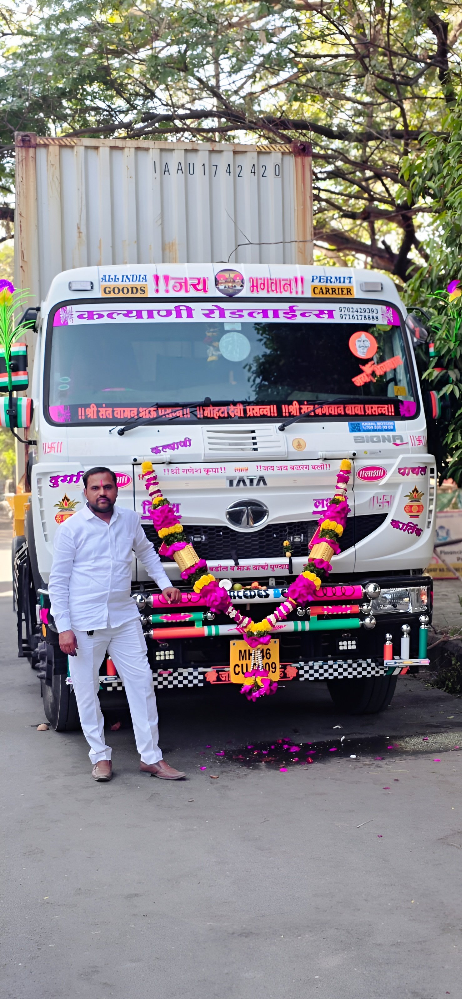 Krishna Sanap standing in front of a Kalyani Roadlines Tata Signa